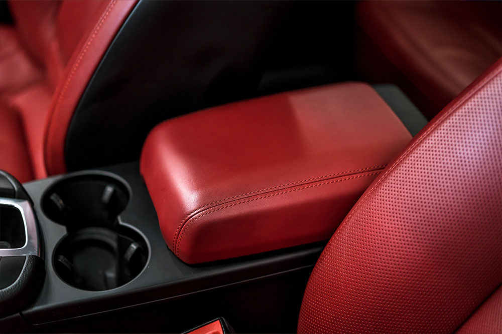 Photo of a car's leather interior arm rest.